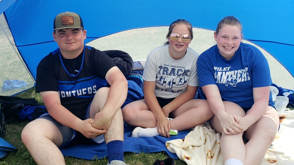Tell, Brooke, and Johanna hanging out during a track meet.
